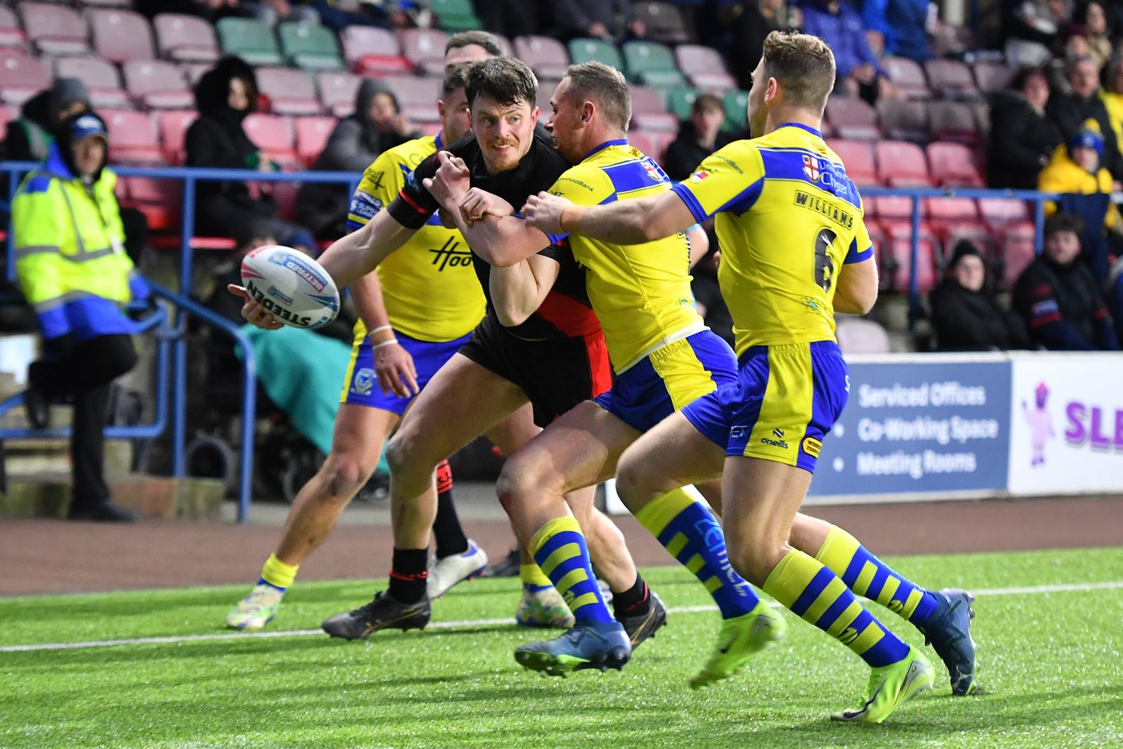 Widnes Vikings forward Rhodri Lloyd offloads the ball against Warrington Wolves in the Challenge Cup